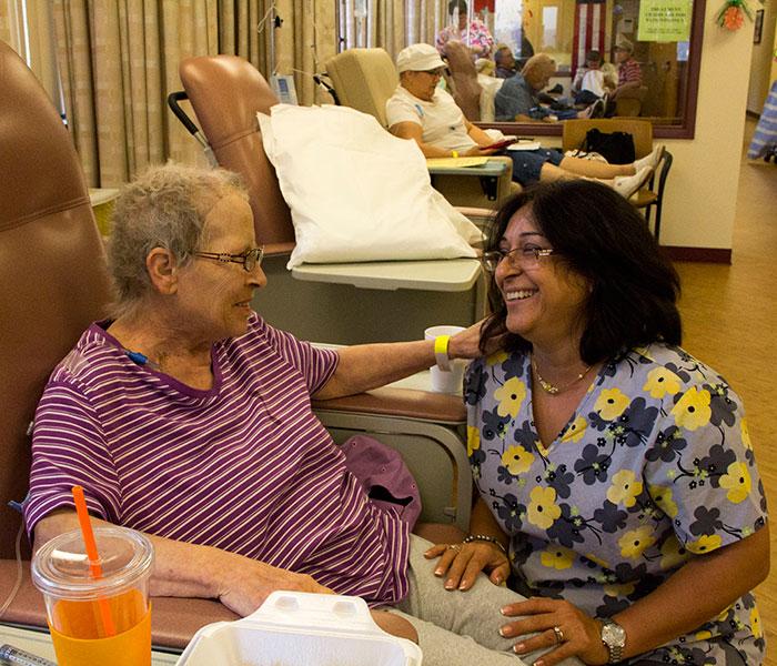 Oncology patient and nurse share a smile