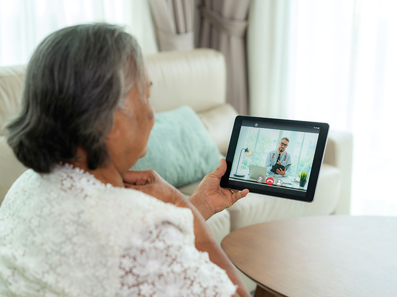 person using a tablet for a telehealth visit