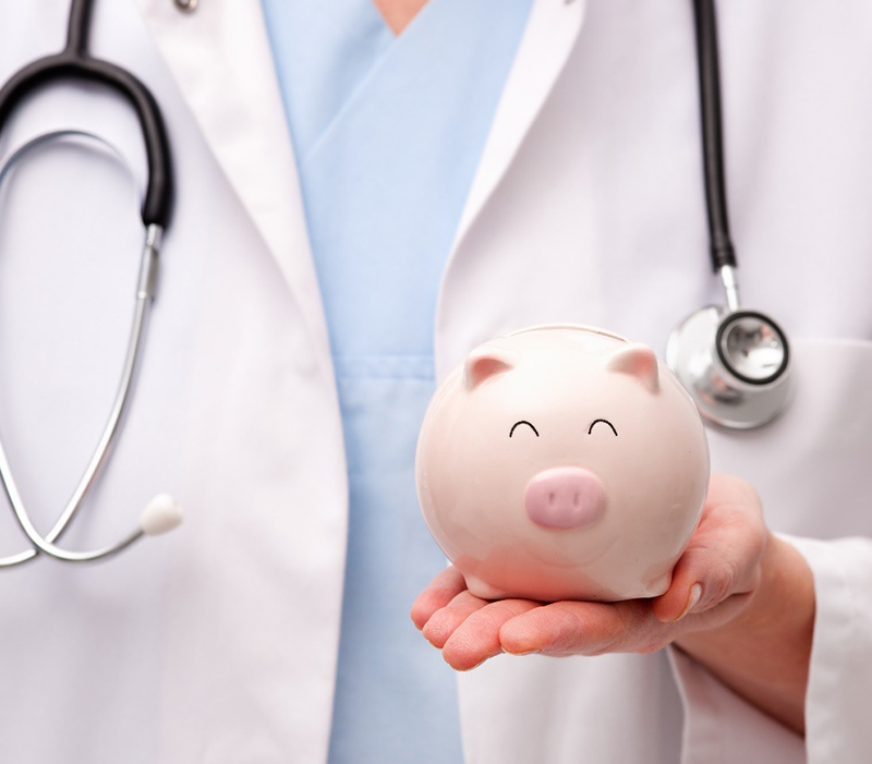 Healthcare professional holding a piggy bank
