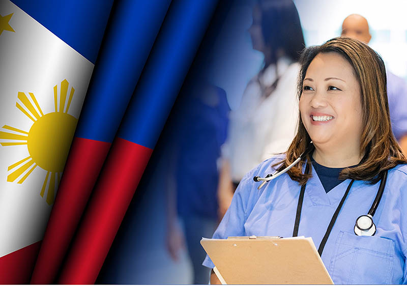 Filipino American History Month nurse standing next to flag