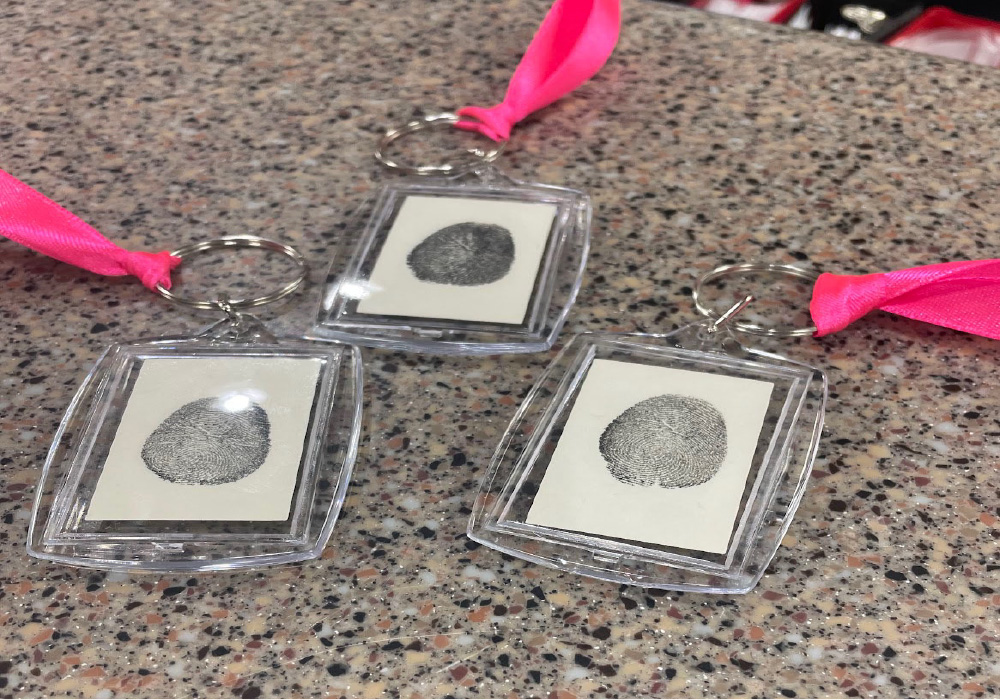 pink tags with fingerprints on the ends representing wishes