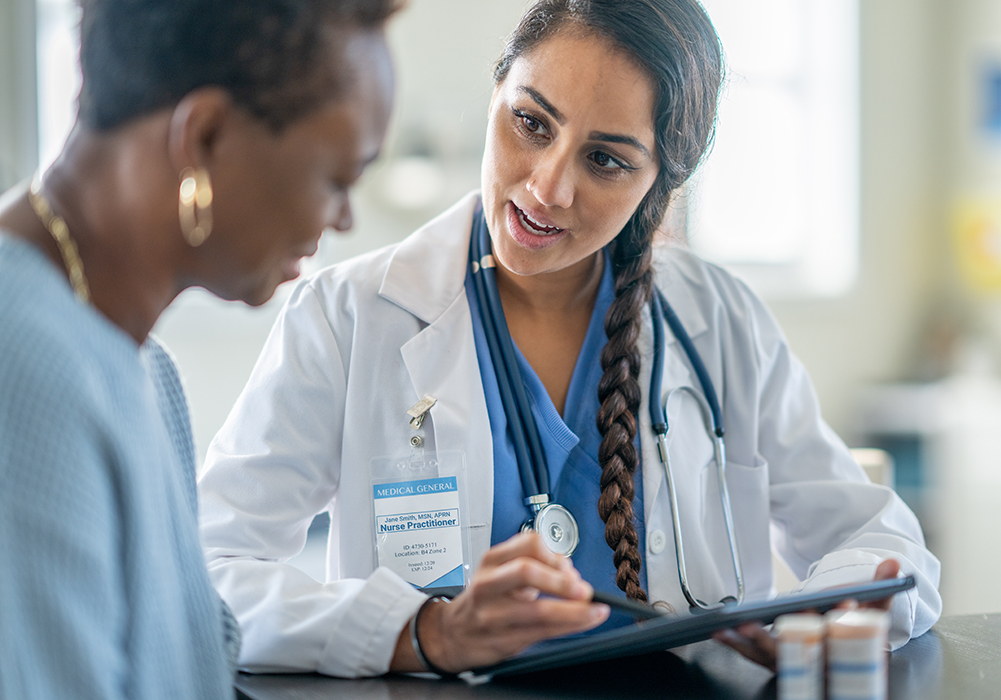 nurse practitioner sitting with patient