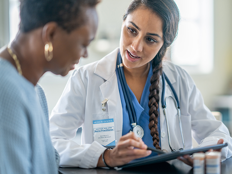 nurse practitioner sitting with patient