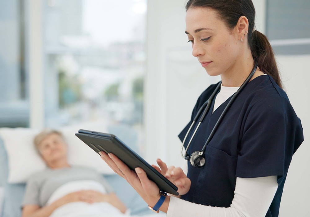 woman holding pad with patient in background