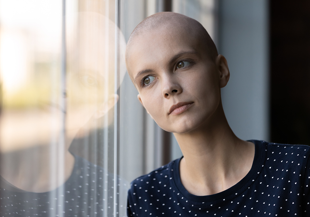 Cancer patient looking out of a window