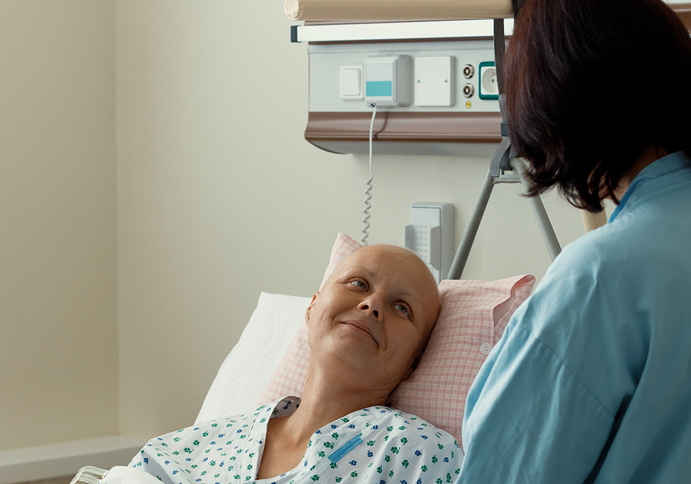 cancer patient looking up at nurse