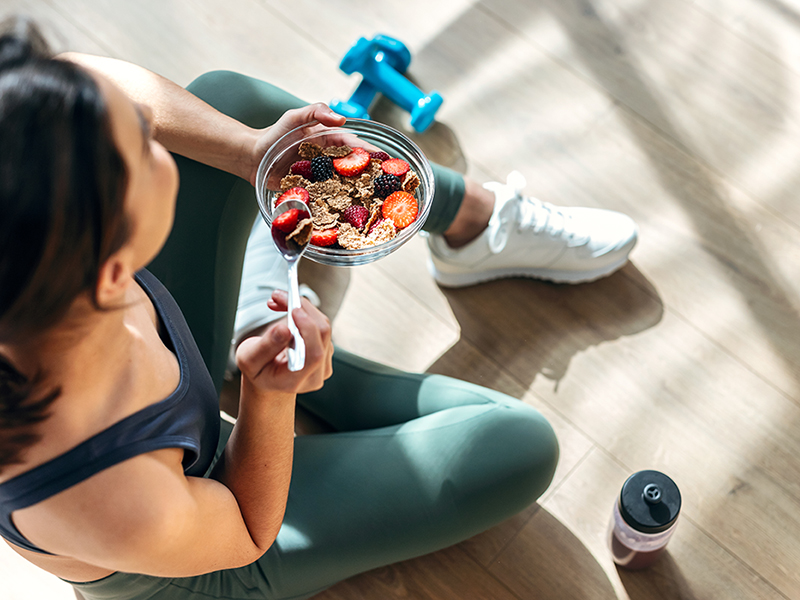 Woman sitting and eating a healthy meal