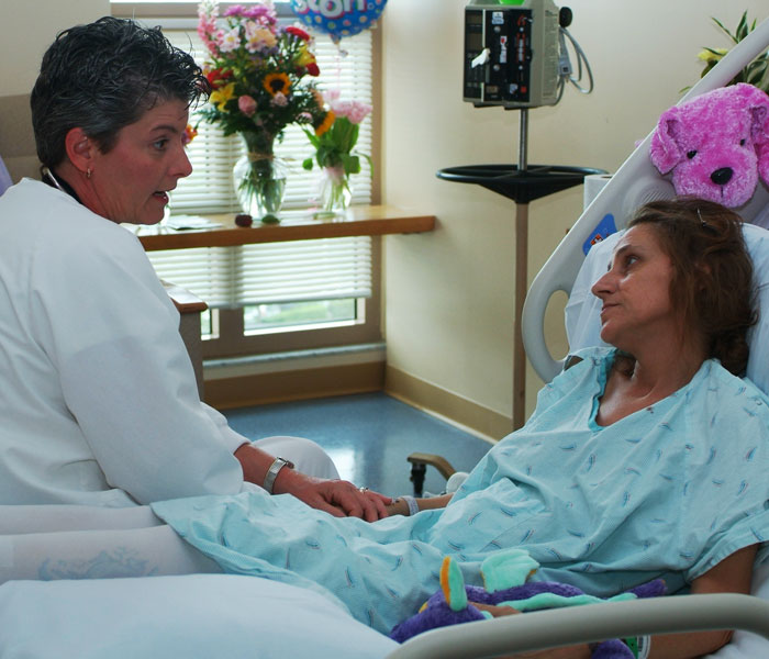 Oncology nurse talking with patient